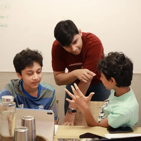 A group discussing their work around a tablet